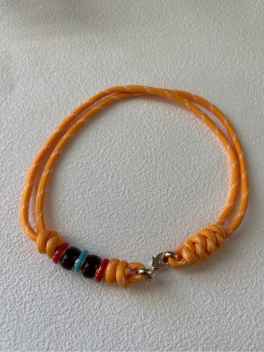 NWOT Roxanne Assoulin Orange Cord Bracelet with Multicolor Beads